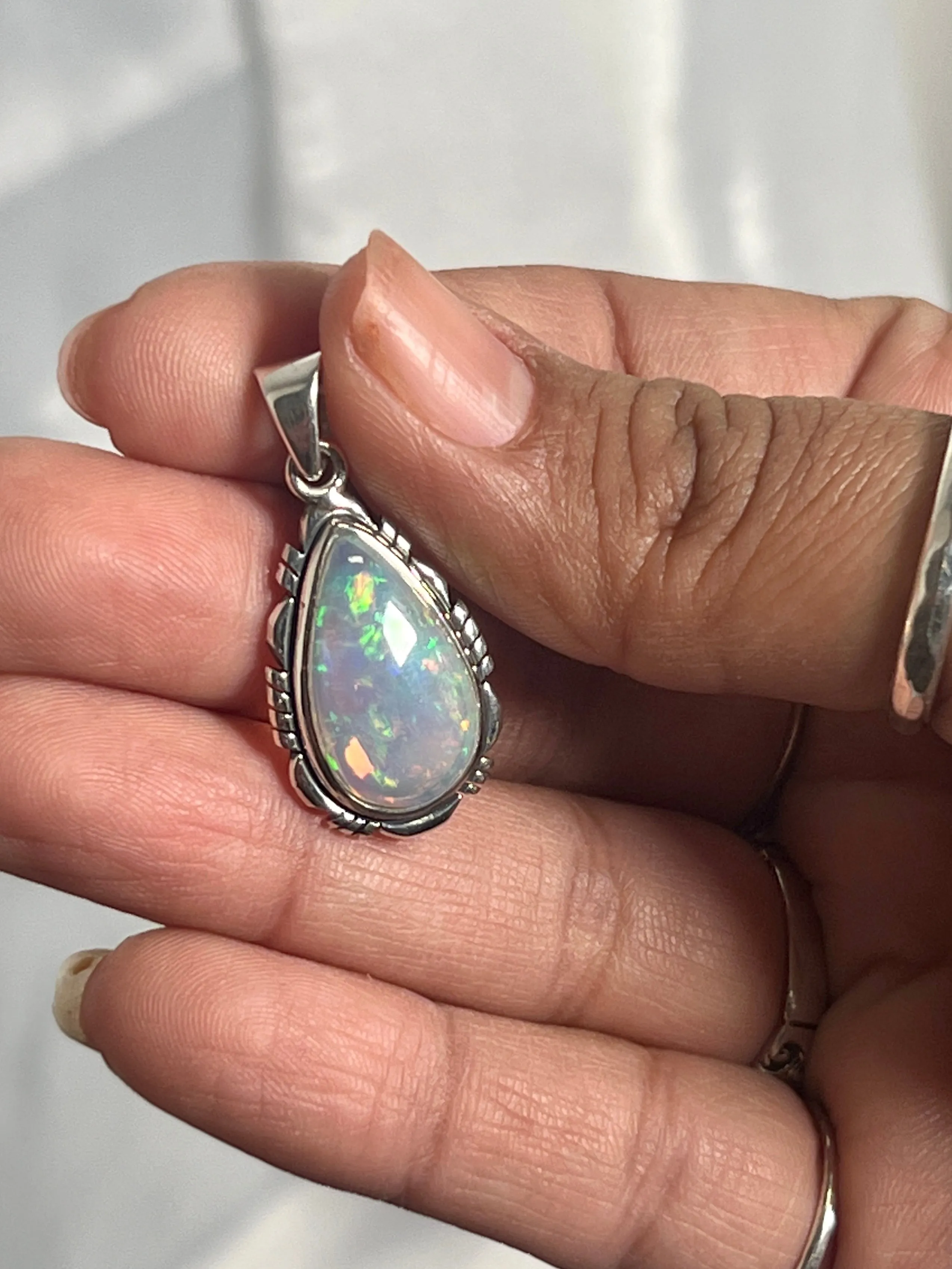 Ethiopian Opal Teardrop Shaped Pendant with Detailed Setting