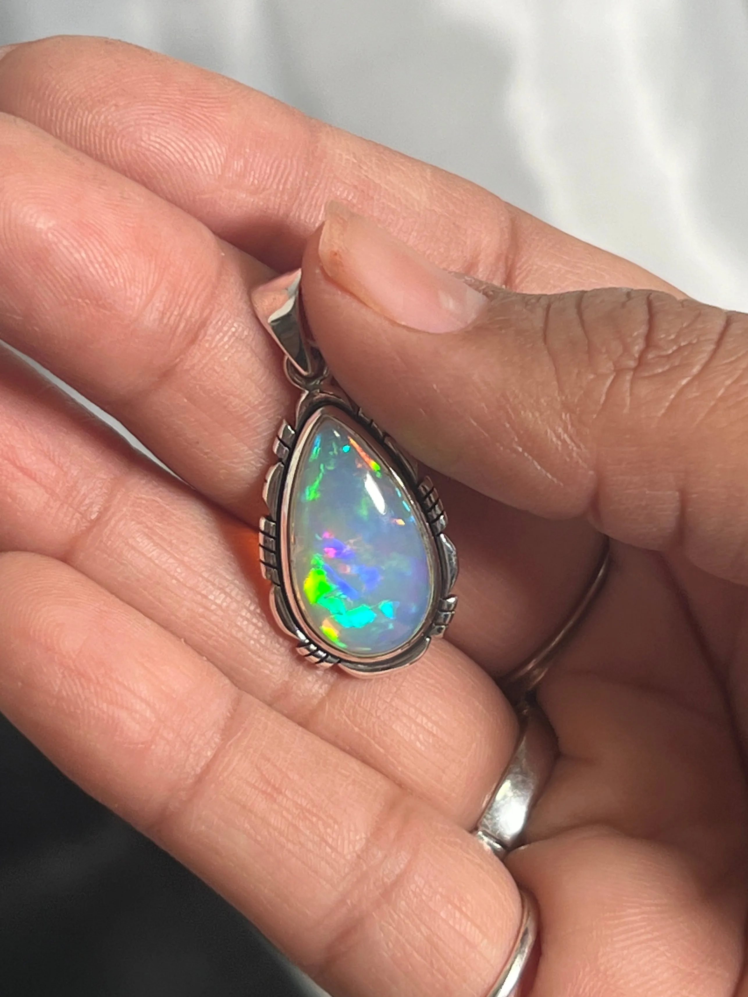 Ethiopian Opal Teardrop Shaped Pendant with Detailed Setting
